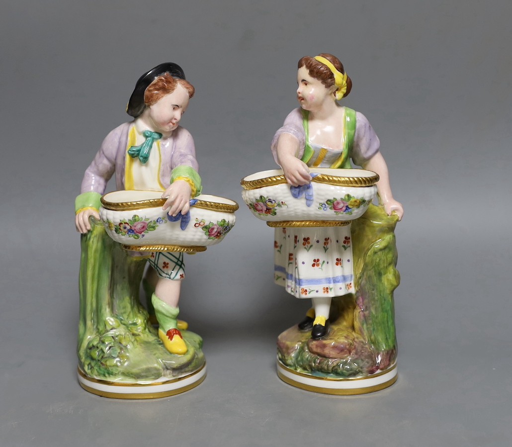 A pair of Victorian Minton's bone china figures holding baskets, 20cms high.